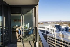 an apartment balcony with a view of a building at Accommodate Canberra - Highgate in Canberra