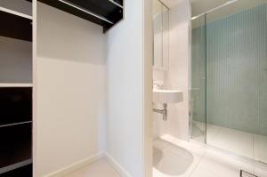 a bathroom with a glass shower and a sink at Accommodate Canberra - Trieste in Canberra