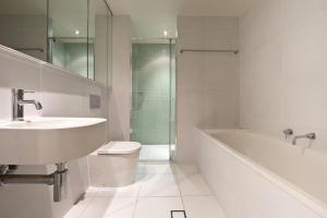 a bathroom with a sink and a tub and a toilet at Accommodate Canberra - Trieste in Canberra