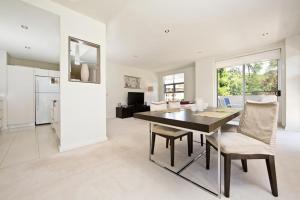 a dining room with a table and chairs at Trieste Apartments Kingston ACT in Canberra