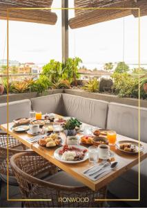 a table with breakfast food on it on a balcony at Ironwood Hotel in Tacloban