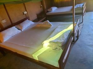 two bunk beds in a room with oneleepthritisthritisthritisthritisthritisthritisthritis at Namaste Bardiya Resort in Bhurkīā +67 photos