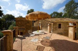 a patio with a table and chairs and an umbrella at Mas Ferrer by 123ole in Sant Andreu del Terri
