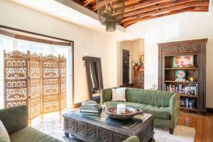 a living room with a couch and a coffee table at Spanish Gem Summer Stay, Filming Events Day Use in Los Angeles