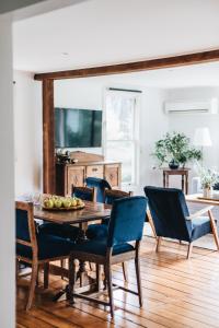 a dining room with a wooden table and chairs at Naivasha Cottage in Deloraine
