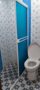 a bathroom with a toilet and a blue door at Posada Dakema in Cartagena de Indias +38 photos