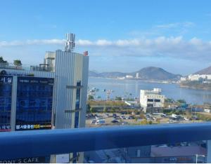 a view of a large city and a body of water at Yeosu Hotel First City in Yeosu