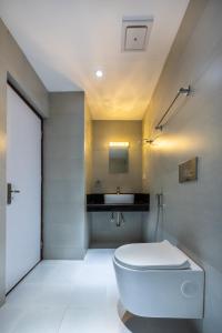 a bathroom with a white toilet and a sink at Hotel Ama-La, Thamel, Kathmandu in Kathmandu