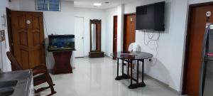a living room with a table and a fish tank at Posada Dakema in Cartagena de Indias
