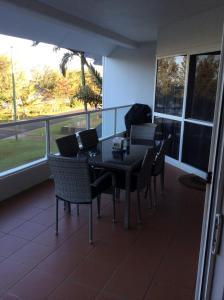 a table and chairs on a balcony with a view at Ulysses 10 in Mission Beach