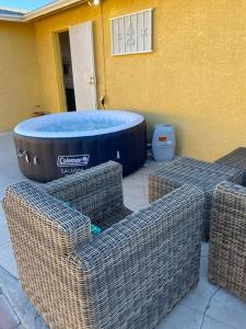 a patio with three wicker chairs and a hot tub at Downtown home with Jacuzzi in Las Vegas