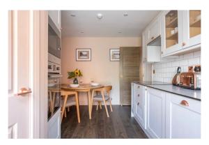 a kitchen with a table and a dining room at Apartment 2, The Old Bank Apartments in Dronfield