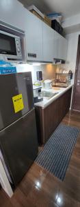a kitchen with a refrigerator with a yellow sign on it at SMDC AIR RESIDENCES in Manila