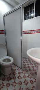 a bathroom with a toilet and a sink at Posada Dakema in Cartagena de Indias