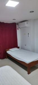 a bedroom with a large bed in a room at Posada Dakema in Cartagena de Indias