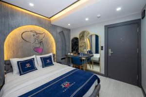 a bedroom with a bed with a painting on the wall at Hotel California in Istanbul +40 photos