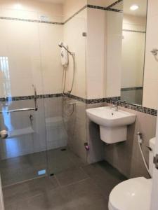 a bathroom with a sink and a shower and a toilet at La La Moon Krabi Poshtel'n' Pool in Krabi