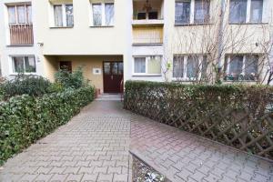 a house with a fence and a brick walkway at Happy Apartments - Economy in Wrocław