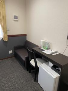 a waiting room with a desk and a couch at Karin doo Hotel in Narita