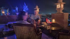 a man and a woman sitting at a table in a restaurant at Hill View in Jodhpur