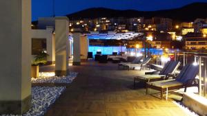 a rooftop patio with lounge chairs at night at Premium Apartment Villa Aristo in Sveti Vlas
