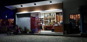 a store front with a motorcycle parked in front of it at Baan Nat The Village SHA Certified in Phuket