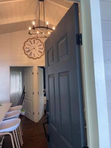 a door in a room with chairs and a clock at Treehouse in Tamanique