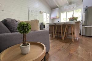 a living room with a couch and a table at Treehouse in Tamanique