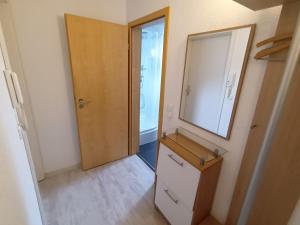 a bathroom with a mirror and a dresser and a door at 3 Zimmerwohnung optimal für Monteure in Reutlingen