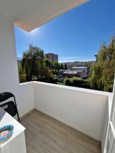 - un balcon blanc avec vue sur la ville dans l'établissement Turquoise apartment, à Petroşani