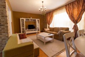 a living room with a couch and a table at Vila cu Mesteceni in Câmpina