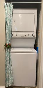 a white refrigerator with a curtain in a room at The big house - 30 days in Kailua-Kona