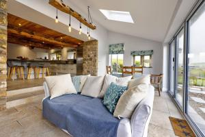 a living room with a couch and a kitchen at Swans Farm in Lancaster