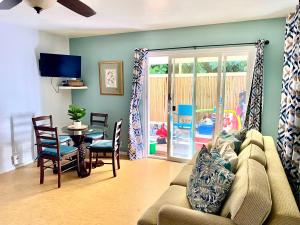 a living room with a couch and a table at The cozy big studio -30 days in Kailua-Kona