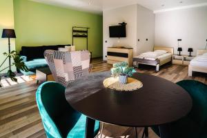 a living room with a table and chairs and a couch at Tenis Park Advantage in Bielsko-Biała