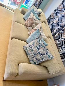 a couch with pillows on it in a store at The cozy big studio -30 days in Kailua-Kona