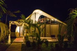 a house is lit up at night at Lucca Resort & Residence in Jepara