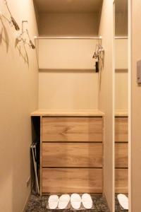 a walk in shower with wooden drawers in a bathroom at Hotel Massimo Mishima in Mishima