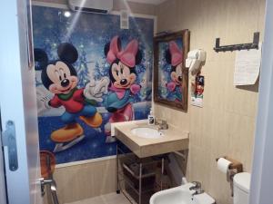 a bathroom with a mickey mouse painting on the wall at ERASE OTRA VEZ en sierra nevada in Sierra Nevada