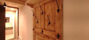a wooden cabinet on a wall in a room at Marina apartment in Stoykite