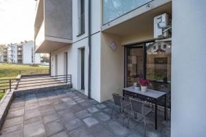 a patio with a table and chairs next to a building at Apartament LUX 3 Cieplice in Jelenia Góra