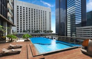 a swimming pool on the roof of a building at ARTOTEL Suites Mangkuluhur Jakarta in Jakarta
