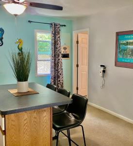 a kitchen with a counter and chairs in a room at My Ohana - 30 days in Kailua-Kona