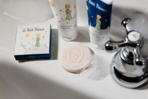 a bathroom sink with a book and a bottle of toothpaste at The 1932 Hotel & Spa Cap d'Antibes - MGallery Collection in Juan-les-Pins