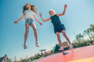 two girls jumping on top of a trampoline at EuroParcs De Rijp in De Rijp