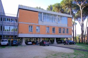 a large building with cars parked in front of it at Casa per Ferie JPII Dom Polski in Rome