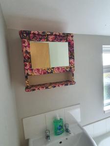 a bathroom with a mirror and a sink at Newcastle Park House in Stoke on Trent