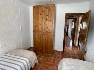 A bed or beds in a room at La casita del pueblo