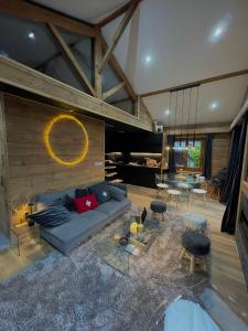 a living room with a blue couch and a table at CHALET MONT BLANC in Combloux