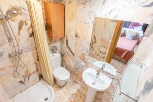 a bathroom with a toilet and a sink and a shower at Nuria Pedrous in Pas de la Casa +14 photos